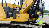 Technician inspecting an excavator